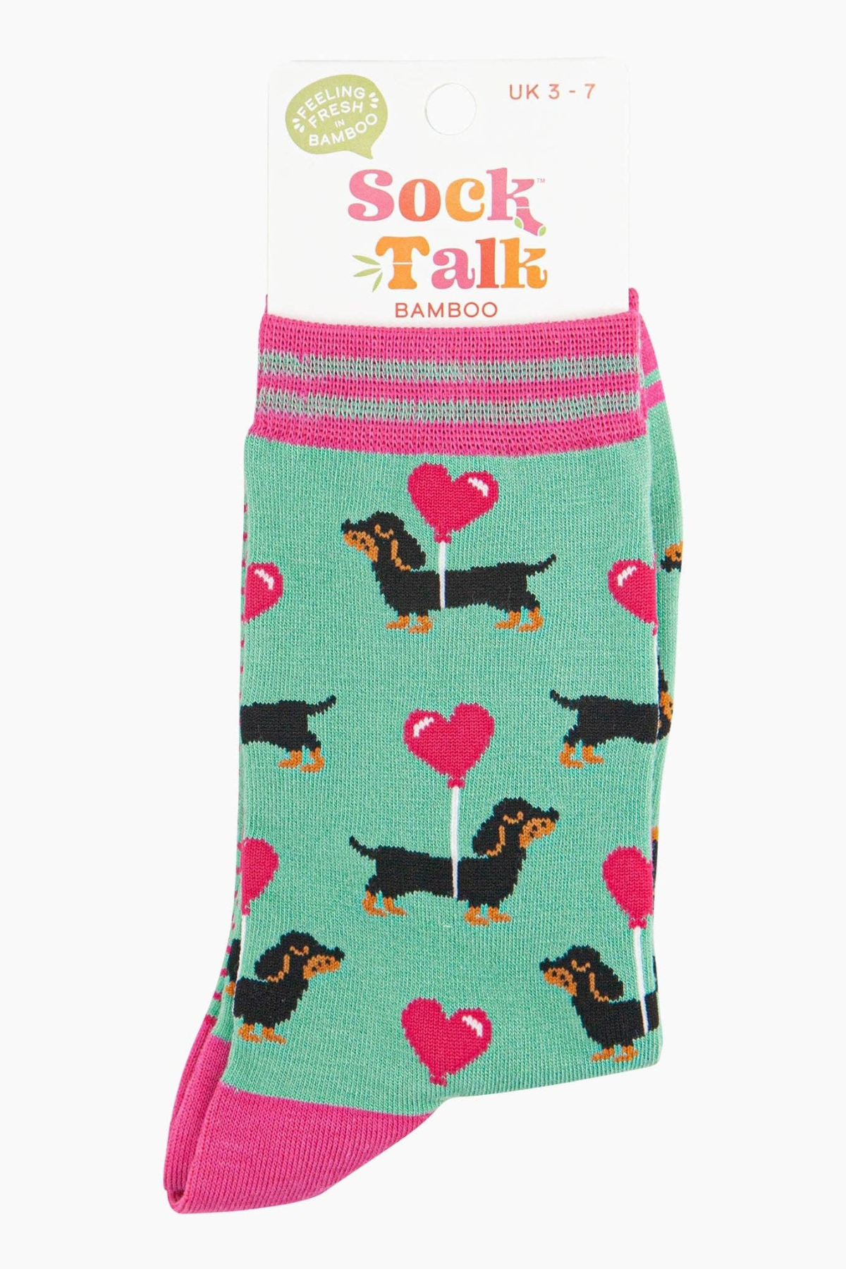 Mintgrønne bambusstrømper med ballon-hjerter og pølsehunde, vist i emballage fra Sock Talk
