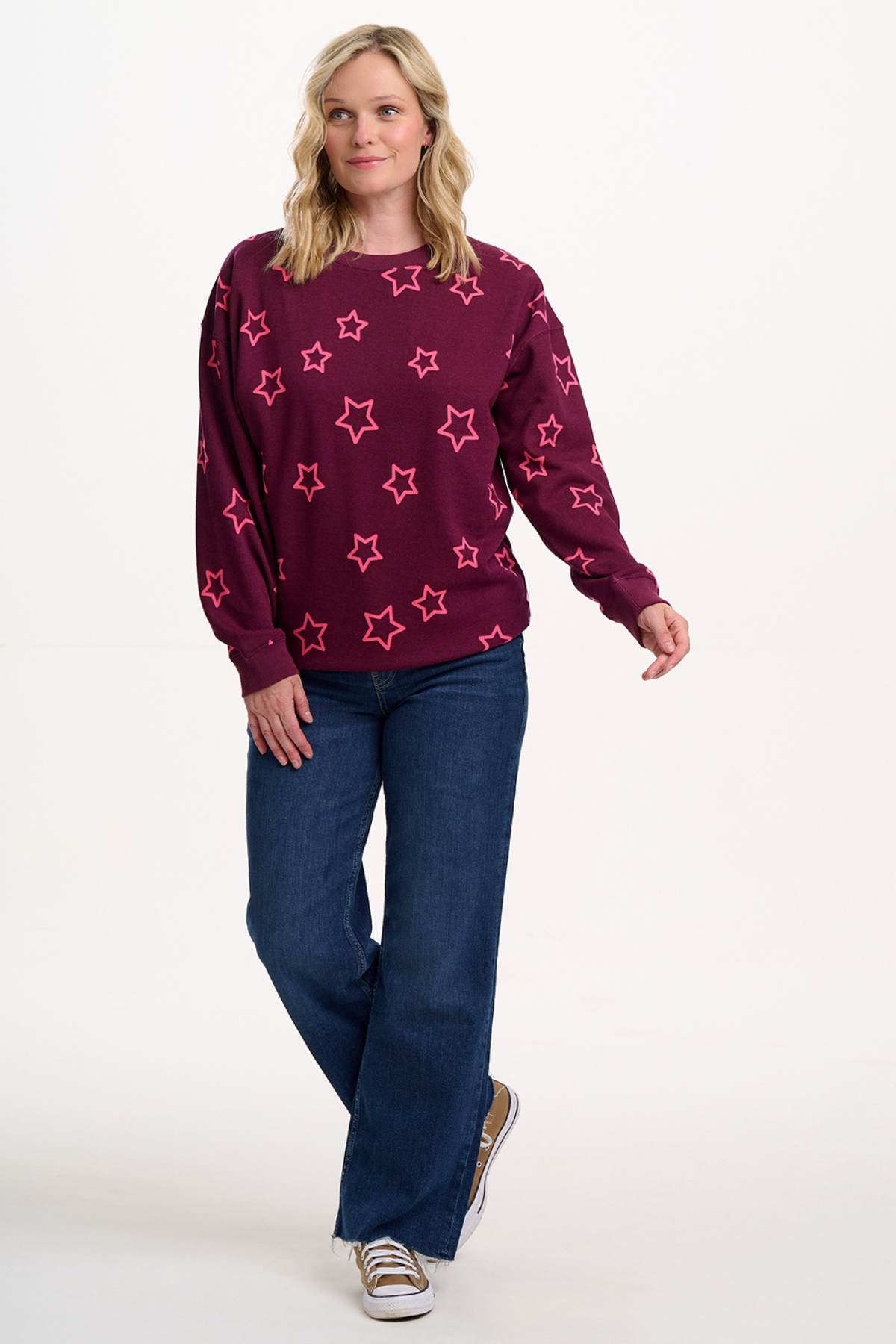 Model iført Eadie Relaxed Sweatshirt og jeans i fuld figur.